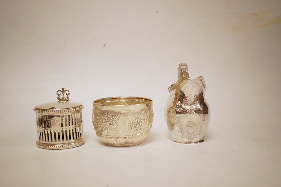 A George III silver helmet shaped cream jug, marks rubbed, 10cm(a.f.), together with a later Victorian silver sugar bowl and similar pierced silver mustard pot, no liner.